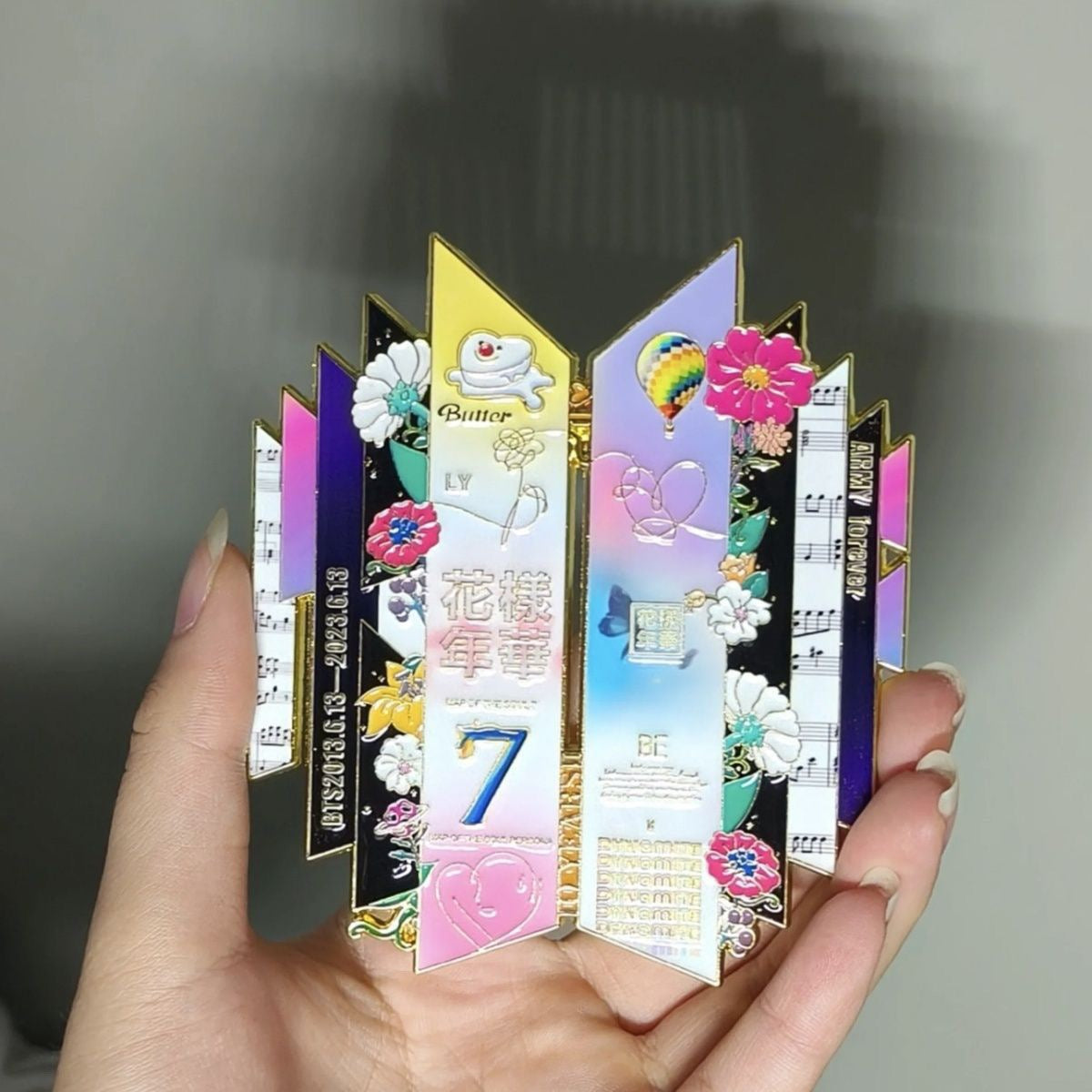 Indoor Handheld Close Up View of BTS 10th Anniversary Enamel Pin