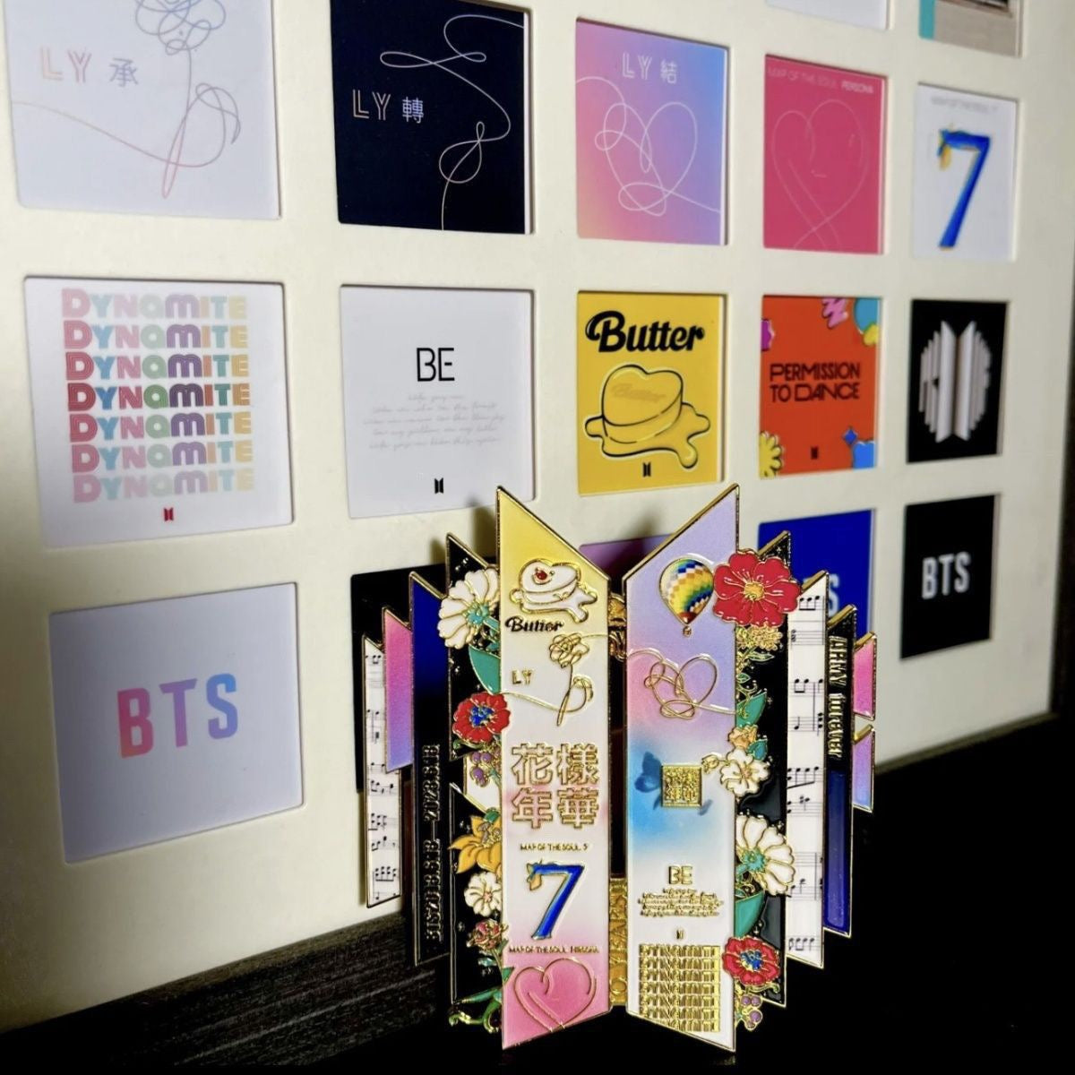 BTS 10th Anniversary Pin Displayed in Front of Kpop Album Wall